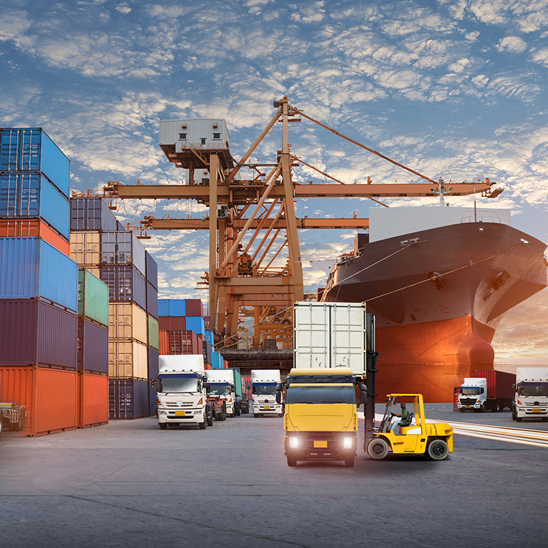 Container truck in ship port for business Logistics and transportation of Container Cargo ship and Cargo plane with working crane bridge in shipyard at sunrise, logistic import export and transport industry background
